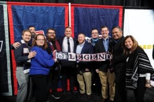 A large group of people holding a banner that says 'legend'.