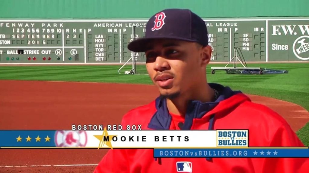 Mookie Betts standing on the field at Fenway Park