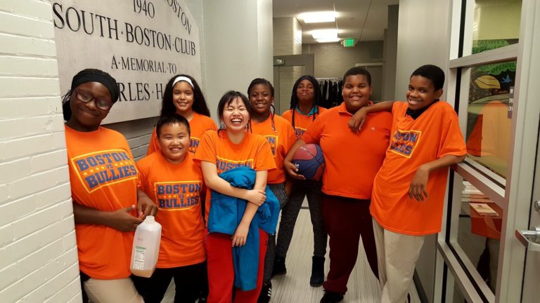 group of students wearing orange Boston vs. Bullies shirts